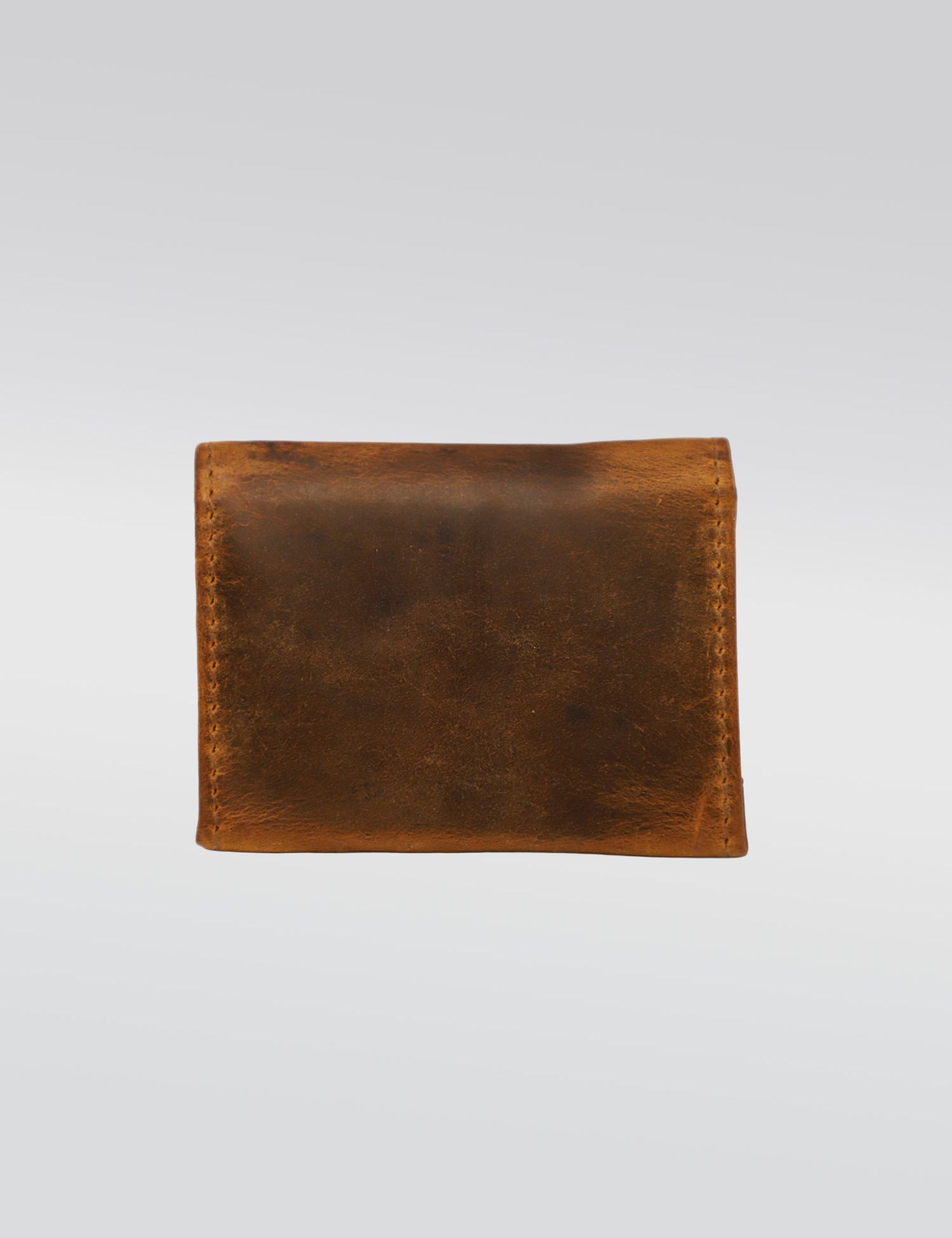 A worn brown leather wallet with visible stitching, centered on a plain white background, showcasing its rustic texture and simplicity.